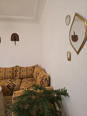 a living room with a couch and a mirror at Dar laarbi Kasbah in Marrakech