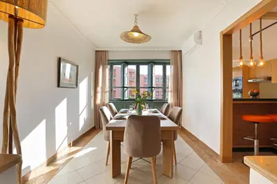 a dining room with a table and some chairs at Spacious 3Br Apartment-Pool&AC- Heart of Marrakech- Hivernage in Marrakech