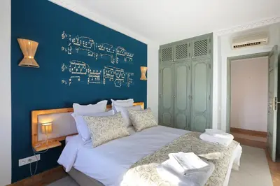 a bedroom with a large bed with a blue wall at Spacious 3Br Apartment-Pool&AC- Heart of Marrakech- Hivernage in Marrakech