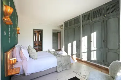 a bedroom with a bed and some green cabinets at Spacious 3Br Apartment-Pool&AC- Heart of Marrakech- Hivernage in Marrakech