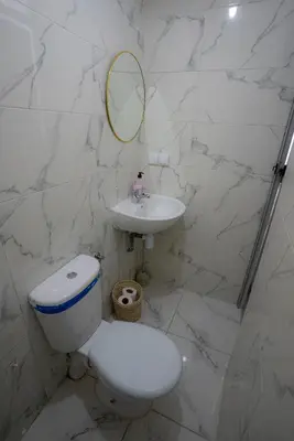 a bathroom with a toilet and a sink and a mirror at Studio Blue Majorelle Marrakech in Marrakech