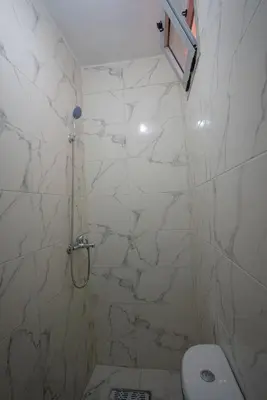 a bathroom with a shower and a toilet at Studio Blue Majorelle Marrakech in Marrakech