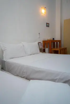 a bedroom with two beds with white sheets at Studio Blue Majorelle Marrakech in Marrakech