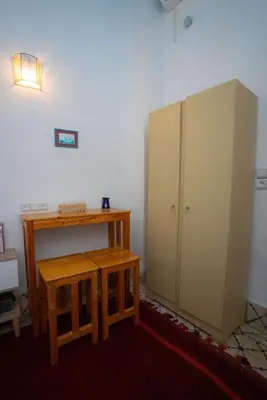 a room with a desk and a cabinet and a table at Studio Blue Majorelle Marrakech in Marrakech