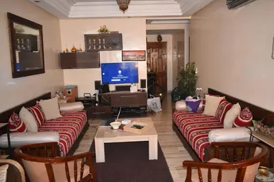 a living room with two couches and a tv at Marrakech Sakan Annakhil im6 n31 in Marrakech