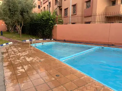 a swimming pool in front of a building at Marrakech Sakan Annakhil im6 n31 in Marrakech
