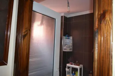 a bathroom with a glass door to a shower at Marrakech Sakan Annakhil im6 n31 in Marrakech