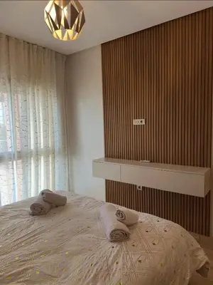 a bedroom with a bed with towels on it at Appartement Marrakech in Marrakech