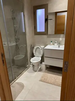 a bathroom with a toilet and a shower and a sink at Appartement Marrakech in Marrakech