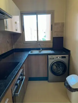 a kitchen with a washing machine and a sink at Appartement Marrakech in Marrakech