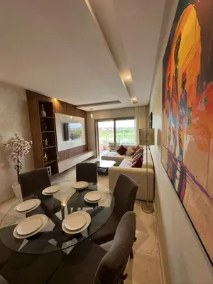 a living room with a table and chairs at Appartement Marrakech in Marrakech