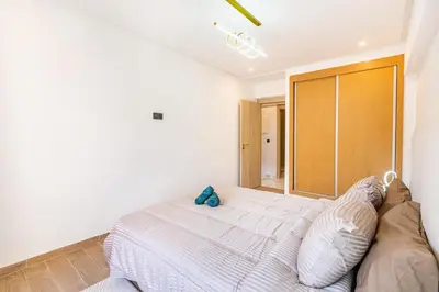a bedroom with a white bed with a stuffed animal on it at Luxury House avec Piscine et Terrasse in Marrakech