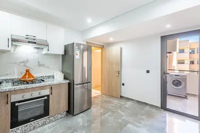 a kitchen with a stove and a refrigerator at Luxury House avec Piscine et Terrasse in Marrakech