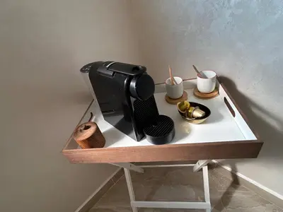 a table with a coffee maker and cups on it at Appartement Haut Standing in Marrakech