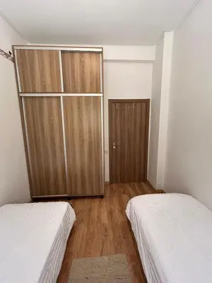 a bedroom with two beds and a closet at Appartement Haut Standing in Marrakech