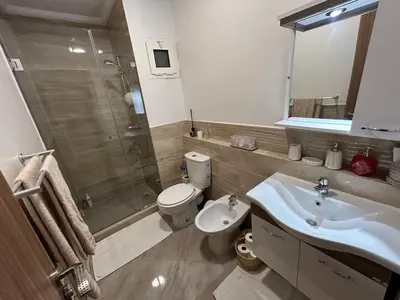 a bathroom with a toilet and a sink and a shower at Appartement Haut Standing in Marrakech