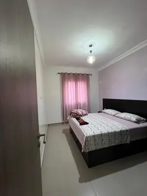 a bedroom with a bed and a pink window at Jardin chrifiya in Marrakech