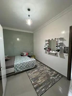 a bedroom with a bed and a mirror and a rug at Jardin chrifiya in Marrakech