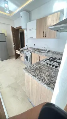 a kitchen with a stove and a counter top at Lovely apartment N15 in Marrakech