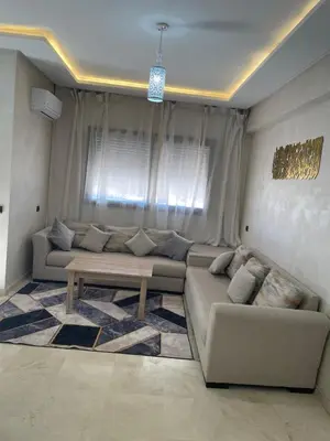 a living room with a couch and a table at Lovely apartment N15 in Marrakech