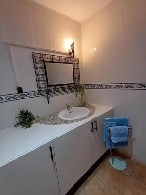 a bathroom with a sink and a mirror at Gueliz Appartement in Marrakech