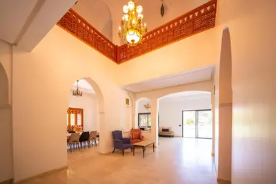 a living room with a chandelier on the ceiling at Villa Jnan Targa Pool & Garden in Marrakech