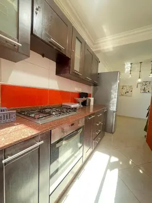 a kitchen with stainless steel cabinets and a stove top oven at Appartement Moderne & Spacieux au Cœur de Guéliz et Proche Majorelle in Marrakech