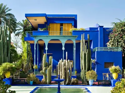 a blue house with cacti in front of it at Appartement Moderne & Spacieux au Cœur de Guéliz et Proche Majorelle in Marrakech