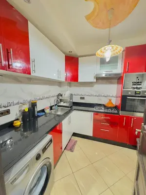 a kitchen with red and white cabinets and a dishwasher at Marrakech in Marrakech