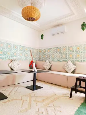 a living room with a couch and a table at Minka Marishan exclusif Riad in Royal destrict in Marrakech