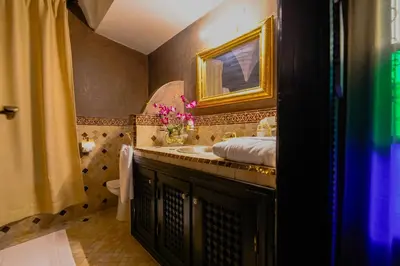 a bathroom with a sink and a mirror at Riad dar Nafaa in Marrakech