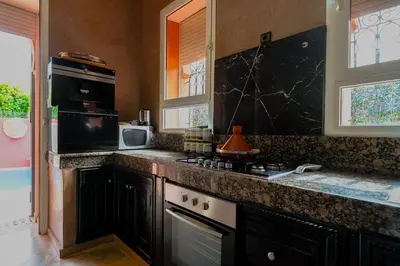a kitchen with a stove and a counter top at Riad dar Nafaa in Marrakech