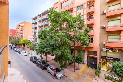 a city street with cars parked next to buildings at Central Gueliz 1-bedroom apartment in Marrakech