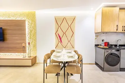 a dining room with a table and chairs in a kitchen at Central Gueliz 1-bedroom apartment in Marrakech