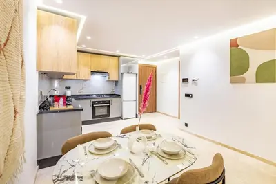 a kitchen and dining room with a table and chairs at Central Gueliz 1-bedroom apartment in Marrakech