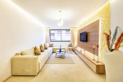 a living room with a couch and a tv at Central Gueliz 1-bedroom apartment in Marrakech