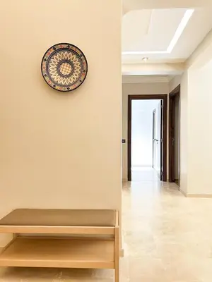 a plate on a wall next to a bench at Menara Prestige Duplex 4BR with Pool Access in Marrakech