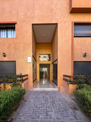 a hallway of a building with a brick walkway at Menara Prestige Duplex 4BR with Pool Access in Marrakech