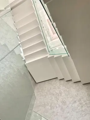 a glass staircase in a room with a tile floor at Villa PALM GOLF AMELKIS in Marrakech
