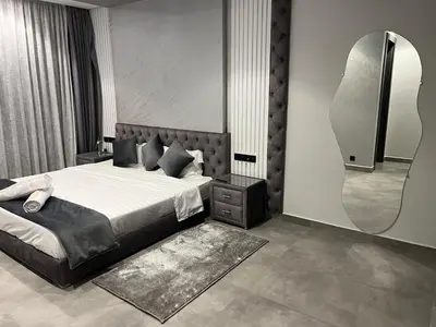 a bedroom with a bed and a large mirror at Villa PALM GOLF AMELKIS in Marrakech