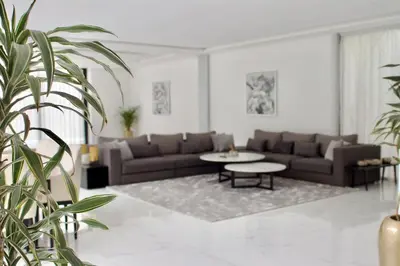 a living room with a couch and a table at Villa PALM GOLF AMELKIS in Marrakech
