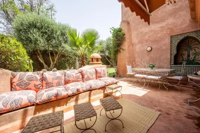 an outdoor patio with a couch and a table at Chez fatina in Marrakech