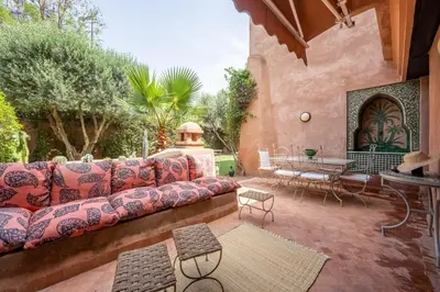 a living room with a couch on a patio at Chez fatina in Marrakech