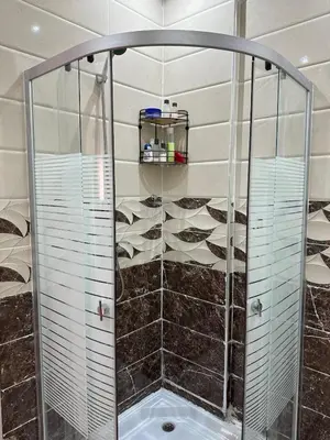 a shower with a glass enclosure in a bathroom at Studio Cosy Proximité Confort in Marrakech