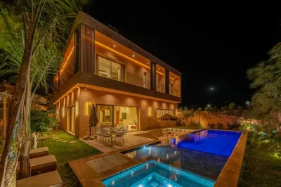 a house with a swimming pool in front of a house at Villa Nabil by TheCasaEdition Cinema, Heated pool & Jaccuzi in Marrakech