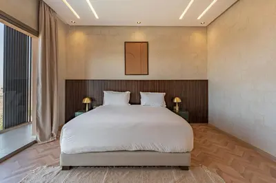 a bedroom with a large bed and a large window at Villa Nabil by TheCasaEdition Cinema, Heated pool & Jaccuzi in Marrakech