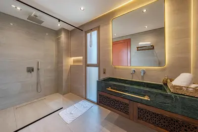 a bathroom with a large mirror and a sink at Villa Nabil by TheCasaEdition Cinema, Heated pool & Jaccuzi in Marrakech
