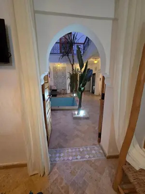 a hallway with an archway with a plant in it at Riad Amanar in Marrakech