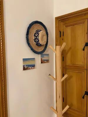 a wooden tree on a wall next to a door at Riad Amanar in Marrakech