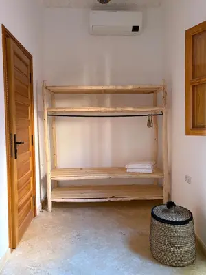 a room with wooden shelves in the corner of a room at Riad Amanar in Marrakech